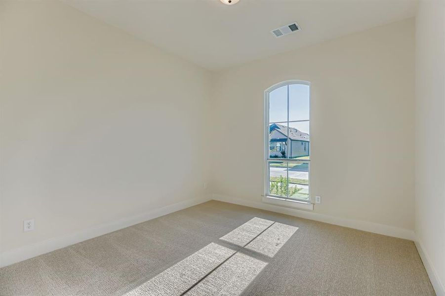 Carpeted empty room with baseboards
