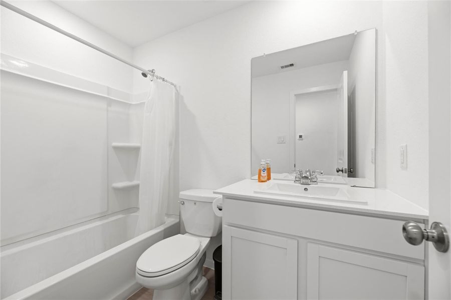Full guest bathroom with a tub/shower combination.