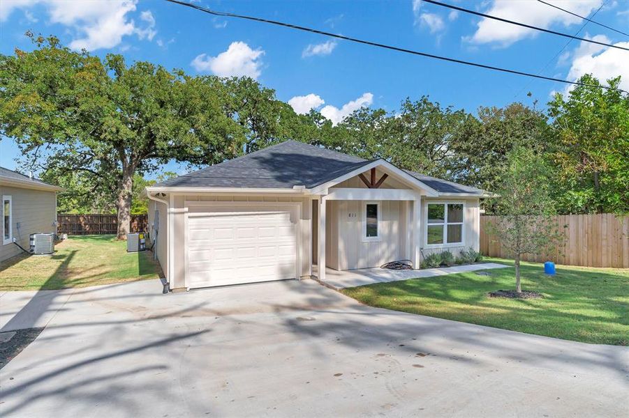 View of front of property featuring roof with shingles, concrete driveway, a garage, board and batten siding, and covered porch View of front of property featuring roof with shingles, concrete driveway, a garage, board and batten siding, and covered porch