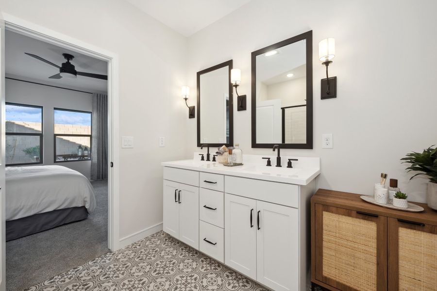 Black-framed mirrors in primary bath