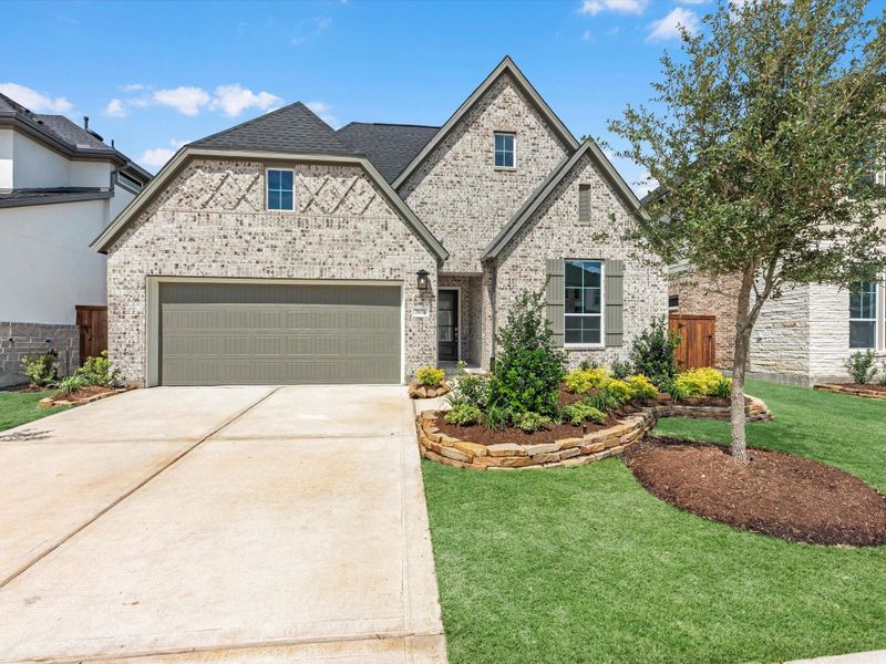 Front exterior of a new home in Tompkins Reserve, Katy, TX, highlighting curb appeal (Image 2). Front exterior of a new home in Tompkins Reserve, Katy, TX, highlighting curb appeal (Image 2).