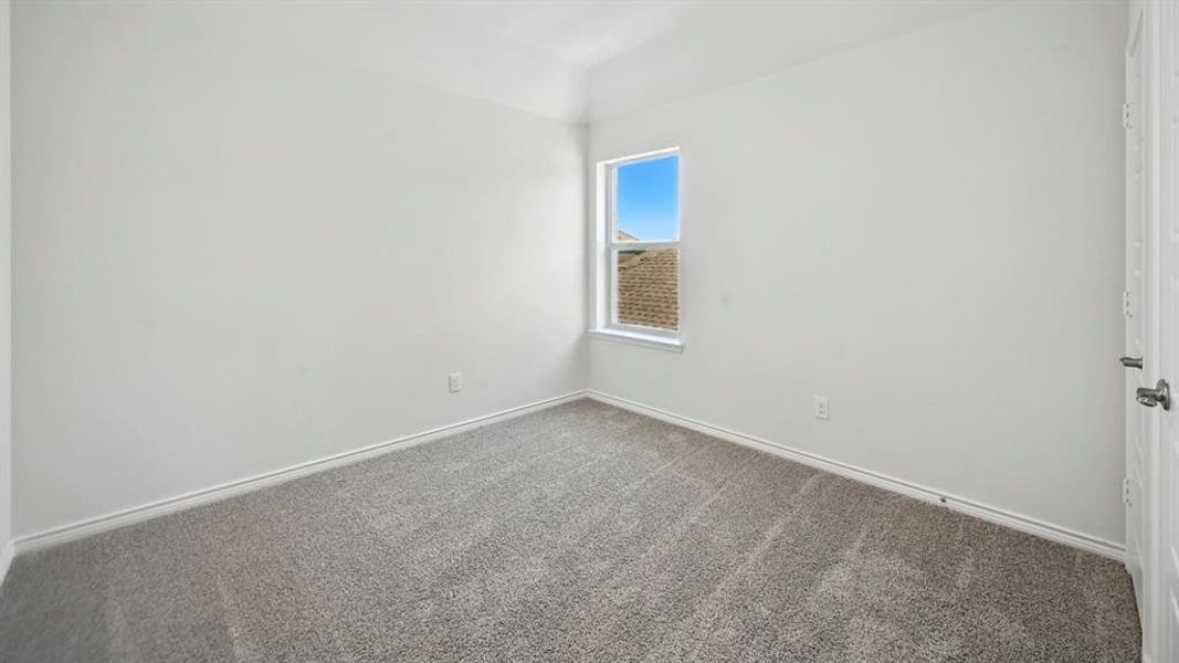 Empty room with carpet flooring and baseboards