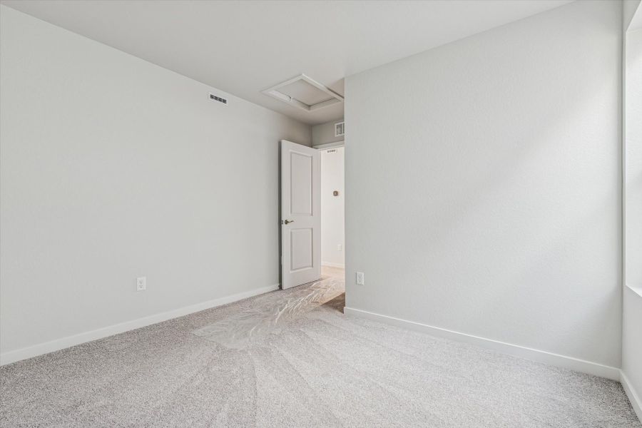 A hallway with white walls.