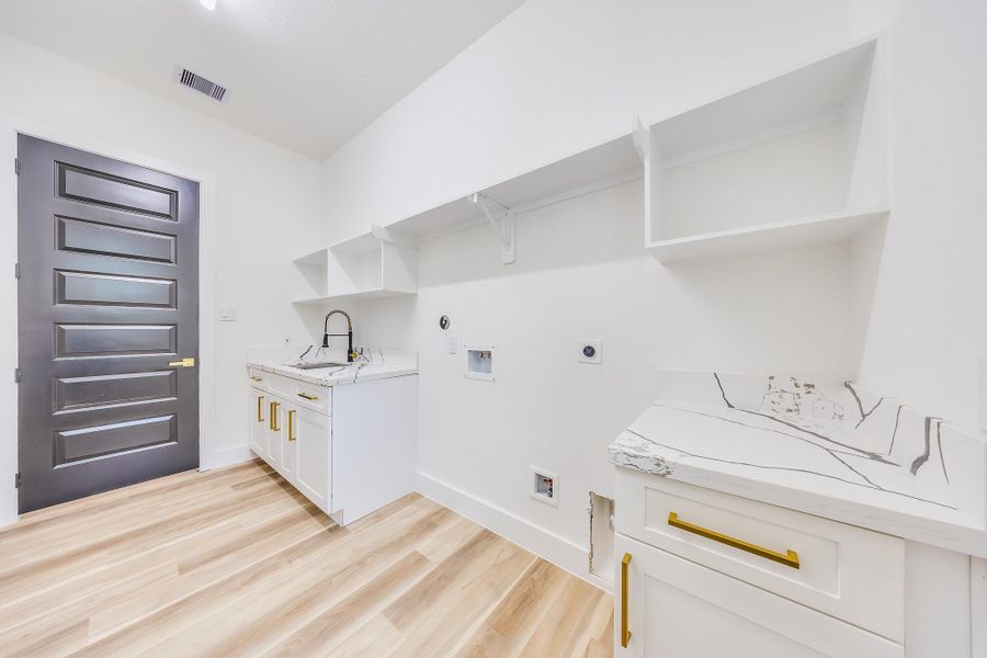 Spacious laundry room with ample storage and workspace, designed for convenience, organization, and efficient household chores. Spacious laundry room with ample storage and workspace, designed for convenience, organization, and efficient household chores.