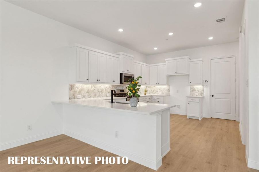 Your new dream kitchen offers a kitchen peninsula that is perfect for a quick bite or homework station.  REPRESENTATIVE PHOTO