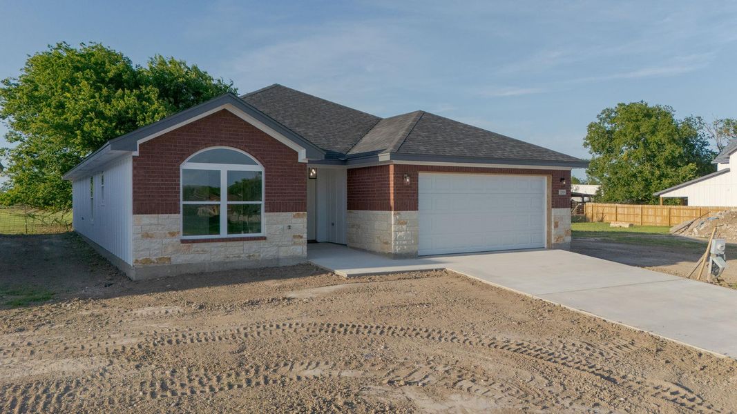 Ranch-style home with roof with shingles, driveway, stone siding, a garage, and brick siding Ranch-style home with roof with shingles, driveway, stone siding, a garage, and brick siding
