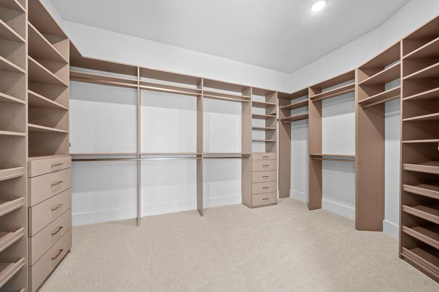 Expansive primary closet with custom shelving, abundant storage, and a thoughtfully designed layout.