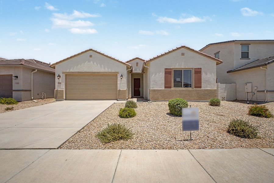 Front exterior of a new home in Wildera, San Tan Valley, AZ, highlighting curb appeal (Image 1). Front exterior of a new home in Wildera, San Tan Valley, AZ, highlighting curb appeal (Image 1).