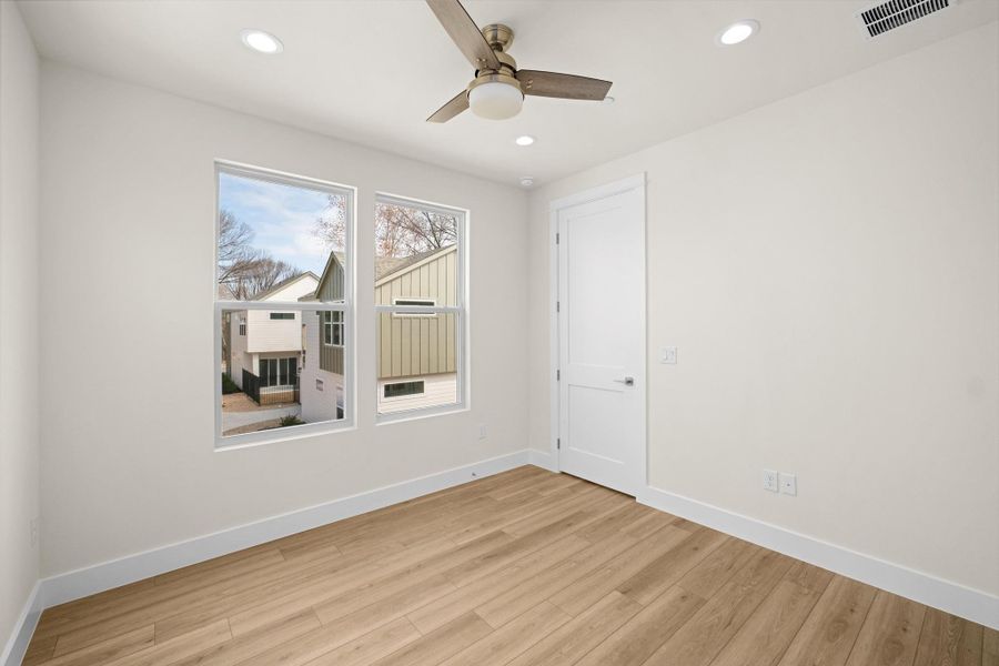 Bedroom #3 with light wood finished floors, a closet, recessed lighting, and a ceiling fan.