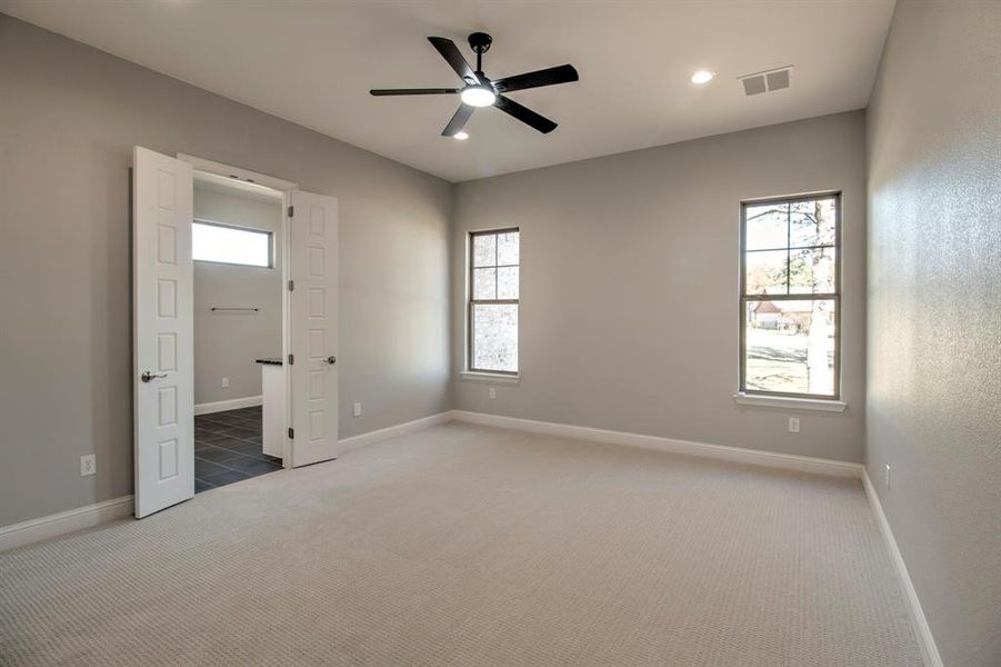 Unfurnished bedroom featuring carpet and ceiling fan