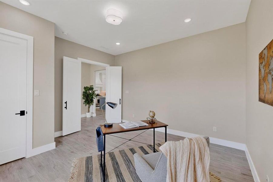 Office area with recessed lighting and light wood finished floors