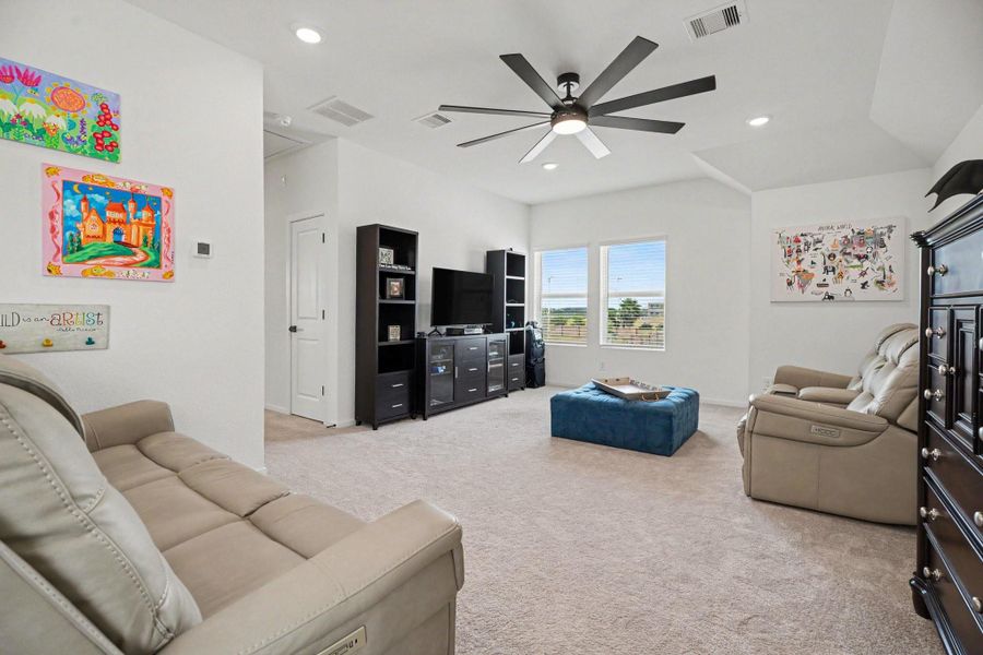 Alternate view of the game room showcasing its generous size, vaulted ceiling, and flexible layout. Alternate view of the game room showcasing its generous size, vaulted ceiling, and flexible layout.
