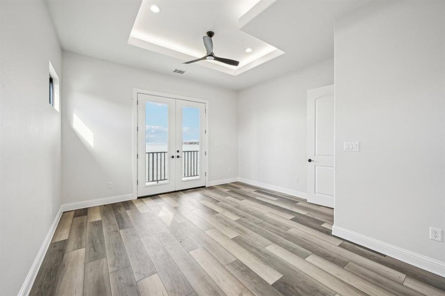 Upstairs guest bedroom with balcony access to lakefront.