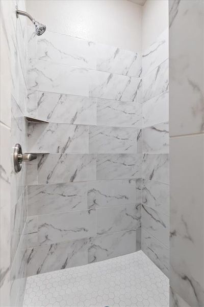 Bathroom featuring a tile shower