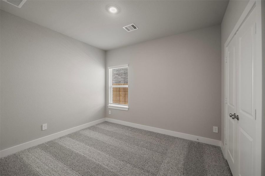 Three spacious secondary bedrooms upstairs, each with large closets and cozy carpet underfoot. Three spacious secondary bedrooms upstairs, each with large closets and cozy carpet underfoot.