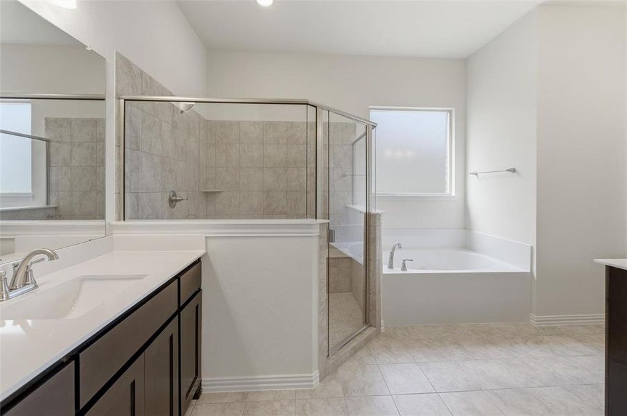 Bathroom with vanity, a stall shower, a bath, and light tile patterned flooring