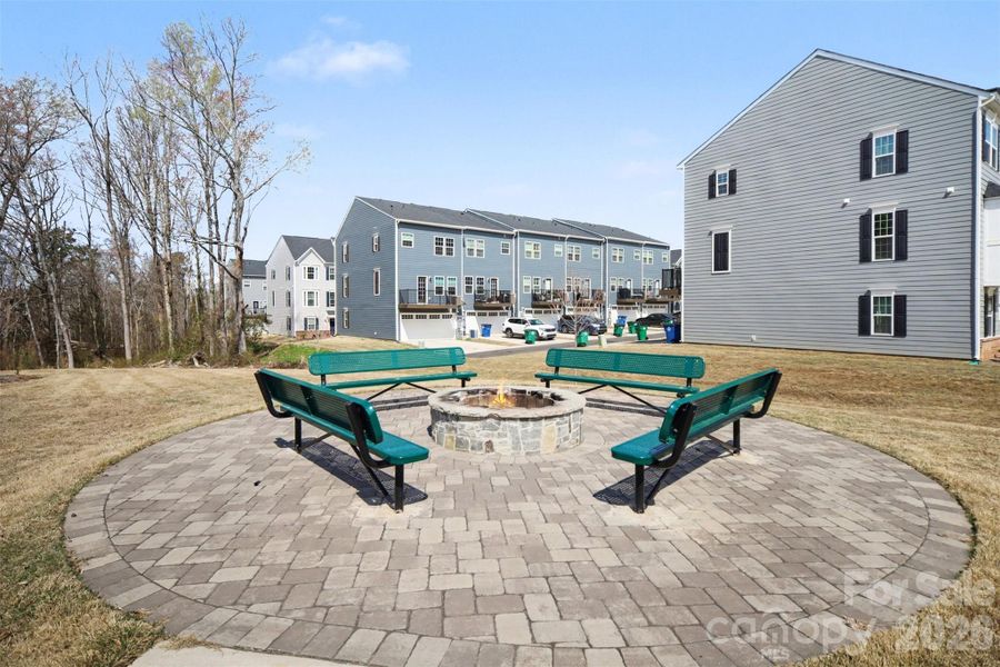Community gathering area featuring a circular stone fire pit with benches