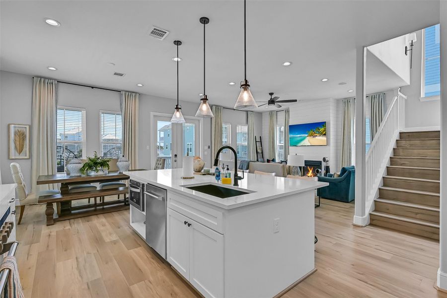 Open sightlines throughout the main level make the home feel bright, connected, and easy to live in. The flow between spaces works perfectly for entertaining.  Notice the under counter microwave drawer.