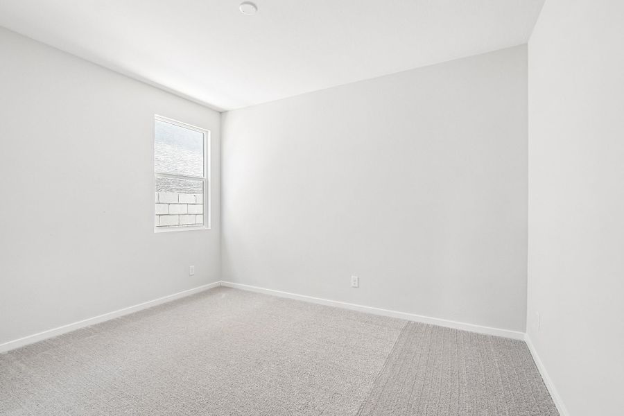 A white room with a carpet.