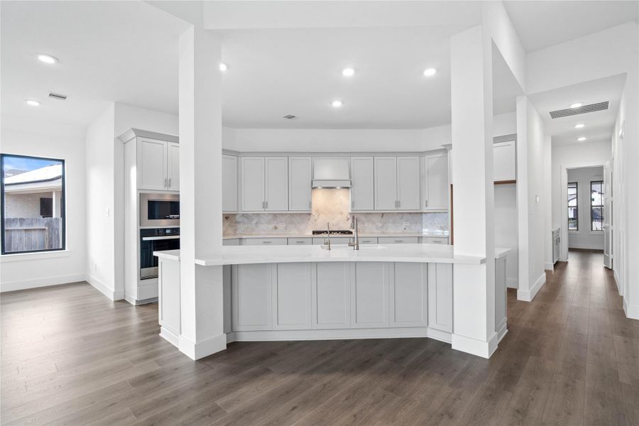 Grand view of this stunning gourmet kitchen which serves as the true heart of the home. Its open-concept layout seamlessly connects to the living spaces for effortless entertaining. Grand view of this stunning gourmet kitchen which serves as the true heart of the home. Its open-concept layout seamlessly connects to the living spaces for effortless entertaining.