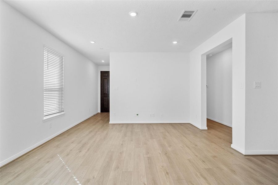 Step inside your new home, where the Layton Lake Soft Beige vinyl plank flooring and fresh, bright paint create a warm and inviting entryway.