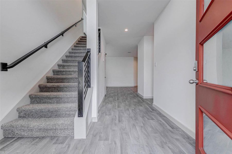 Step inside to sleek, contemporary finishes,beautiful flooring, a neutral palette, and iron stair railings create a clean, cohesive aesthetic. The wide foyer flows effortlessly into the open-concept main floor, creating an airy, welcoming atmosphere perfect for greeting guests or everyday family life. Step inside to sleek, contemporary finishes,beautiful flooring, a neutral palette, and iron stair railings create a clean, cohesive aesthetic. The wide foyer flows effortlessly into the open-concept main floor, creating an airy, welcoming atmosphere perfect for greeting guests or everyday family life.