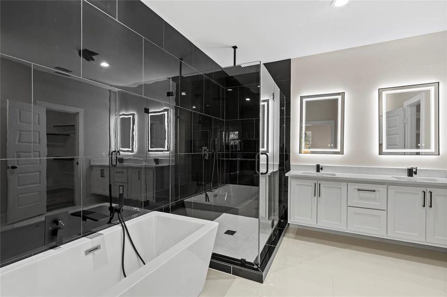 Bathroom featuring tile patterned flooring, vanity, and separate shower and tub