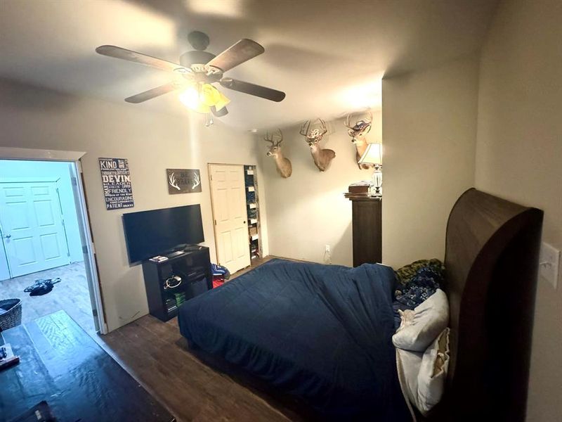 Bedroom with wood finished floors and ceiling fan Bedroom with wood finished floors and ceiling fan