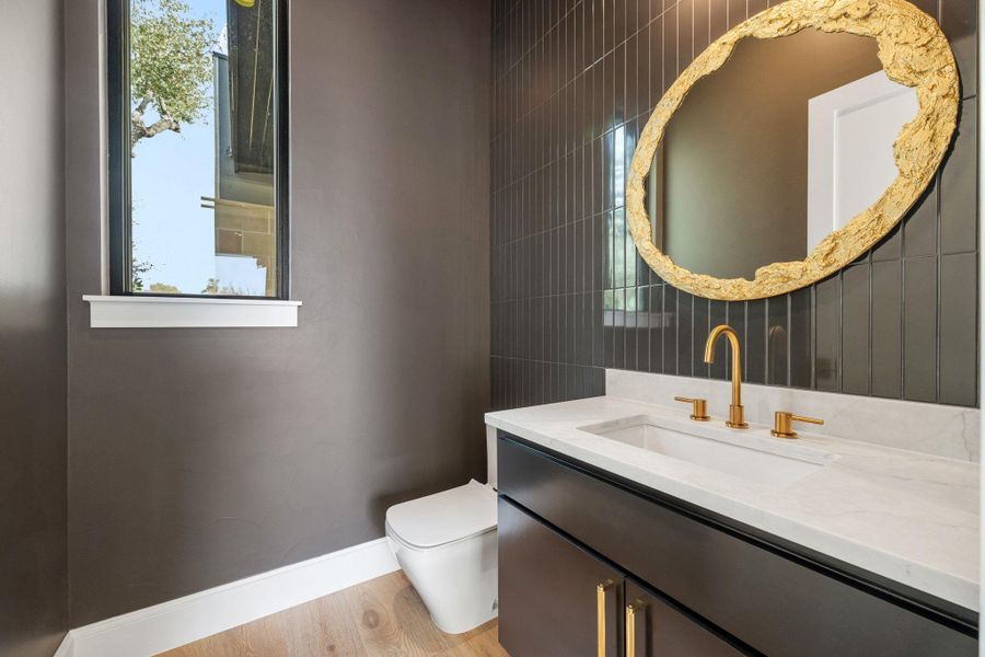 Half bath with vanity and light wood-style floors