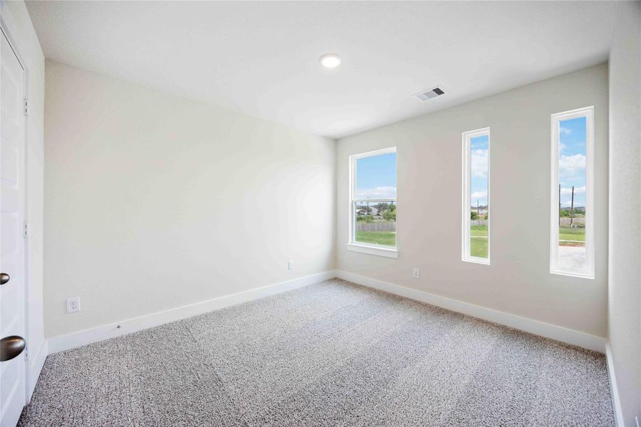 Enjoy another light and bright secondary bedroom, featuring tall ceilings and recessed lighting.