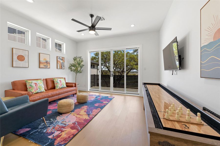 This stylish full bath features sleek gold hardware, elegant lighting, and a herringbone-tiled shower wall with built-in niche. A sophisticated space that perfectly blends function and design for guests or everyday use.