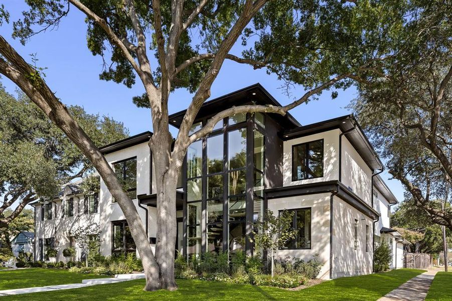 View of side of property featuring stucco siding and a lawn View of side of property featuring stucco siding and a lawn