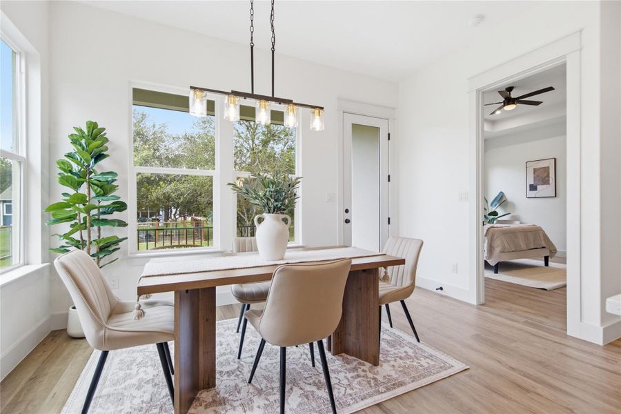 A chic dining area featuring hardwood floors and abundant natural light. A chic dining area featuring hardwood floors and abundant natural light.
