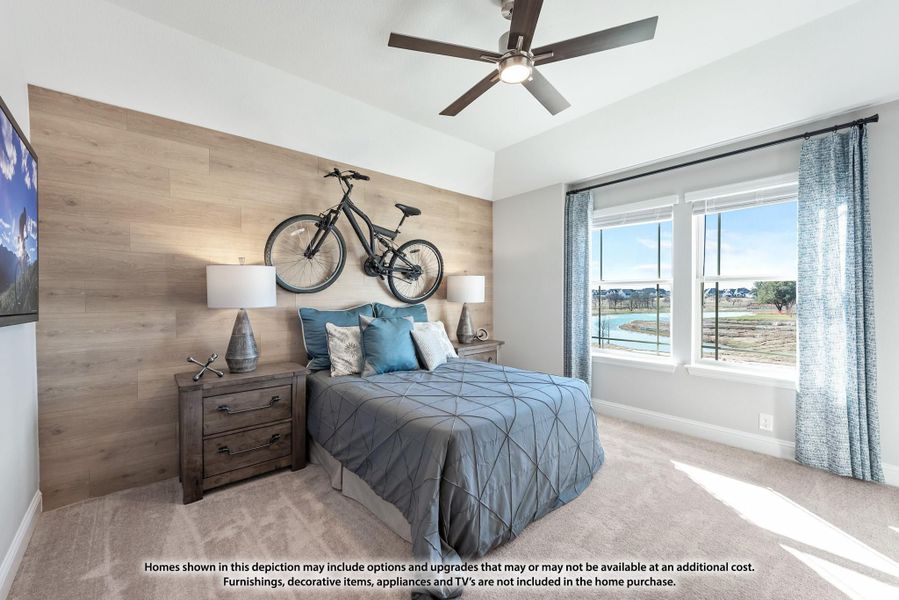Bedroom with wood accent wall, ceiling fan, carpet flooring, and large window with outdoor view Bedroom with wood accent wall, ceiling fan, carpet flooring, and large window with outdoor view