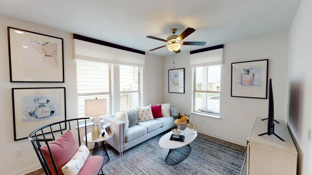 Living area with baseboards and a ceiling fan
