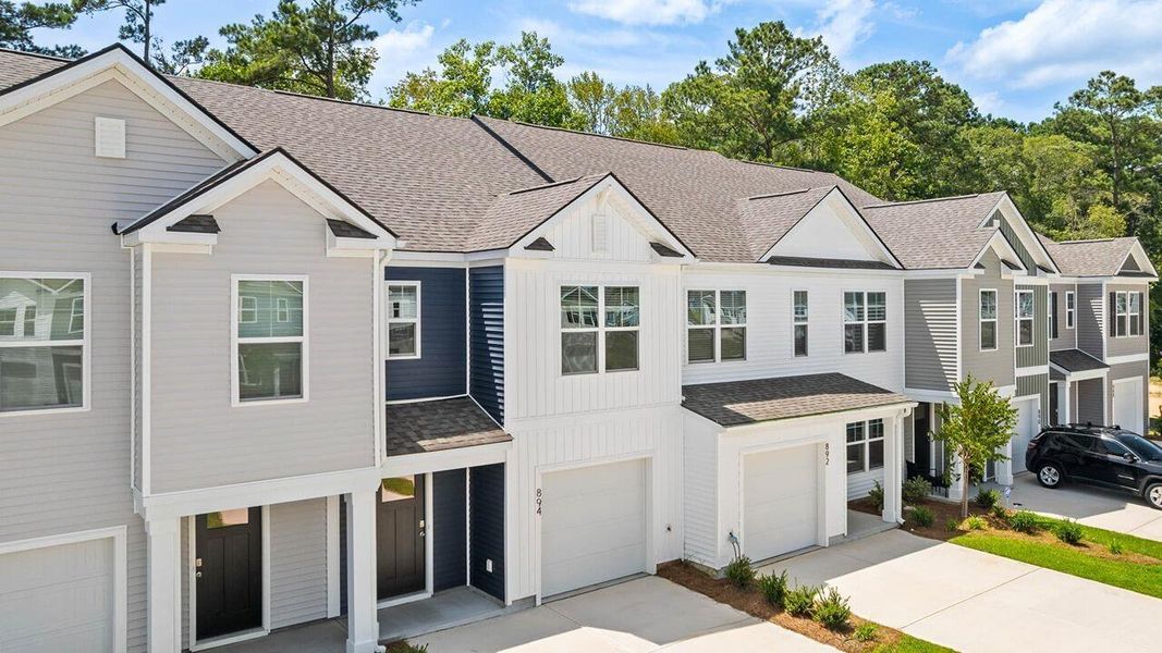 Front exterior of a new home in Pine Hills Townhomes at Cane Bay, Summerville, SC, highlighting curb appeal (Image 2).