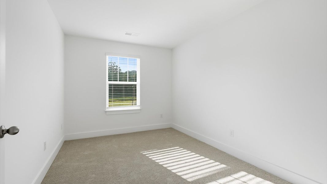 Refined bedroom design with a large window for daylight-filled mornings and peaceful views