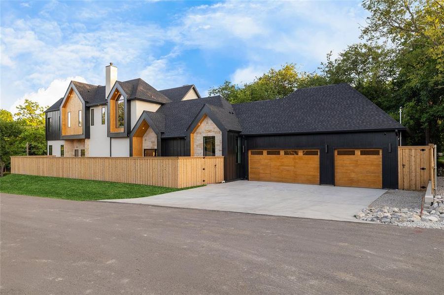 Contemporary exterior featuring a stone and stucco facade with vertical wood accents Contemporary exterior featuring a stone and stucco facade with vertical wood accents