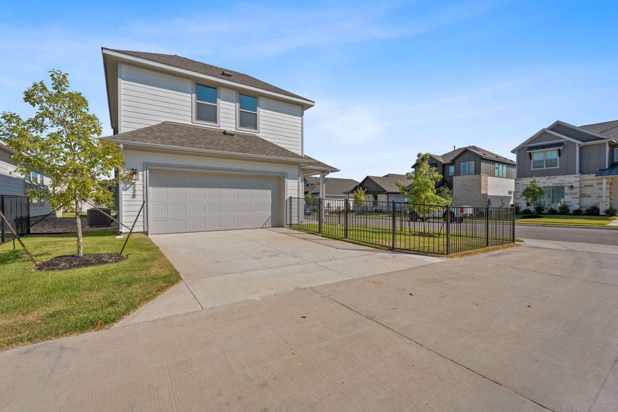 View of front of property with driveway, roof with shingles, an attached garage, and a residential view View of front of property with driveway, roof with shingles, an attached garage, and a residential view
