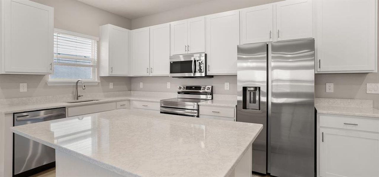 Furnished interior view inside a new home in Estates at Hickory Cove - Bungalows, St. Cloud (Image 6).