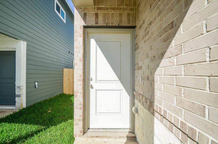 This stunning brick and covered porch creates a unique and stylish facade.