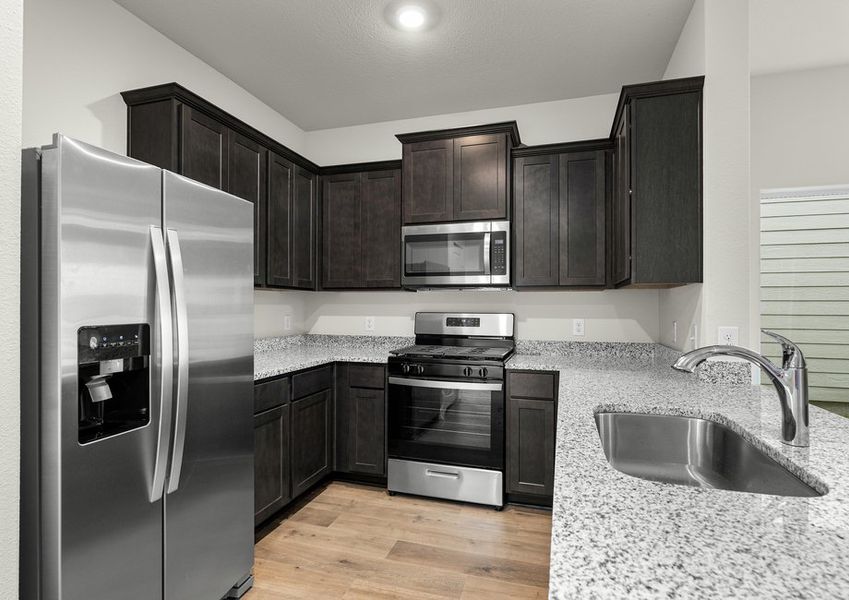 The kitchen has beautiful wood cabinetry.