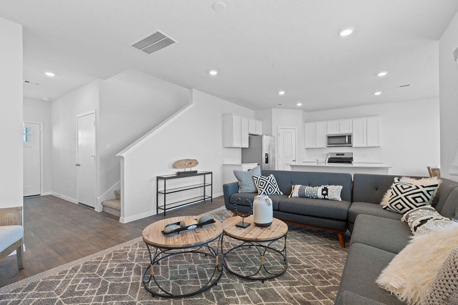 Living area featuring stairs, recessed lighting, and dark wood finished floors Living area featuring stairs, recessed lighting, and dark wood finished floors