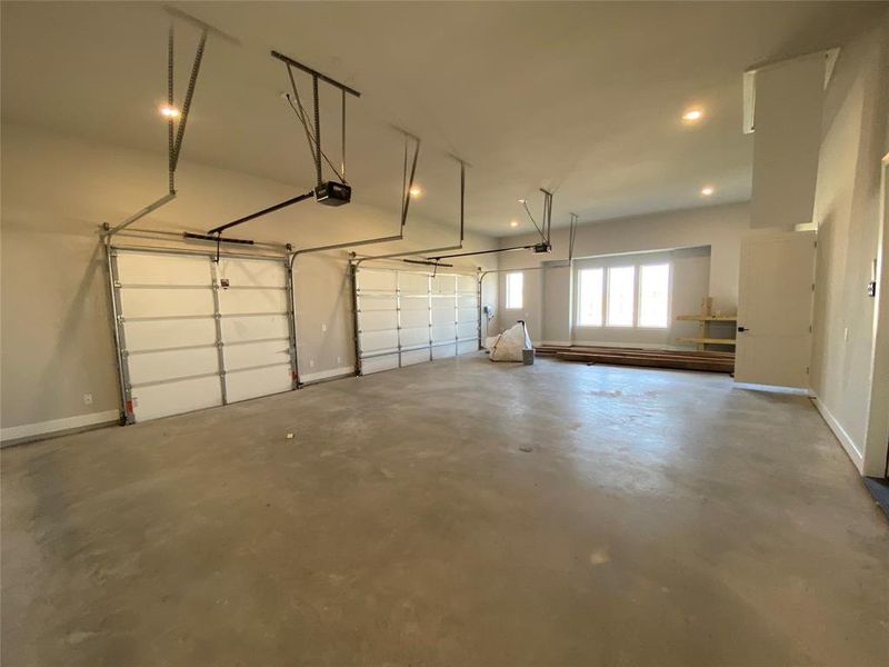 Garage featuring a garage door opener and recessed lighting