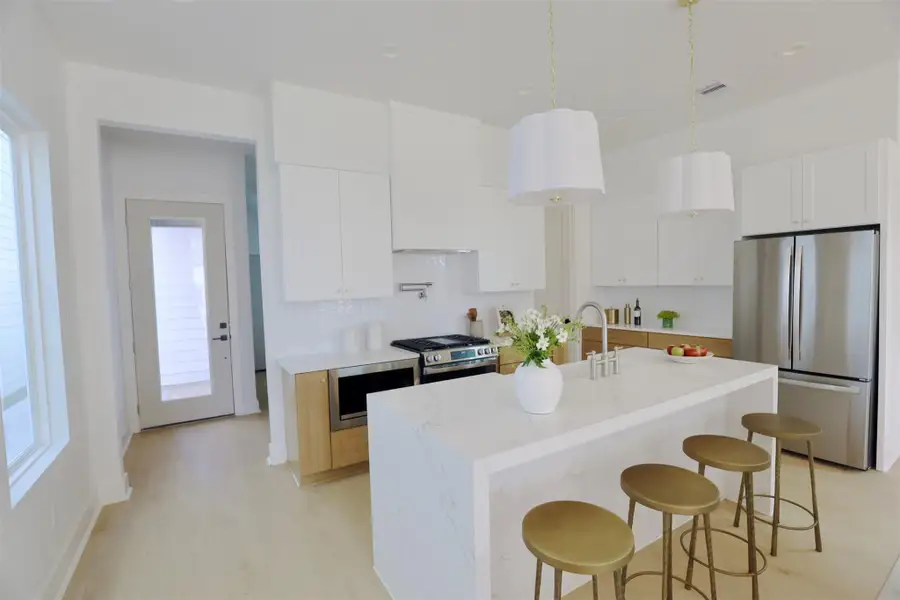 The charming kitchen is brightened by natural light from the many windows incorporated into the design.