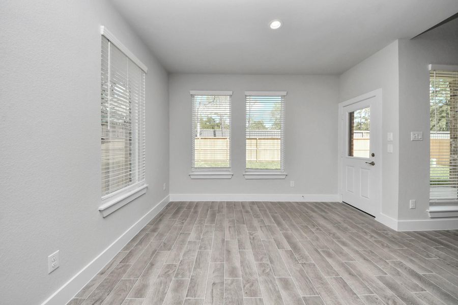 Enjoy breakfast with ease in the connected and cozy breakfast area, seamlessly integrated with the kitchen for utmost convenience. Step through the back door for a breath of fresh air onto the covered patio, extending your living space to the outdoors.