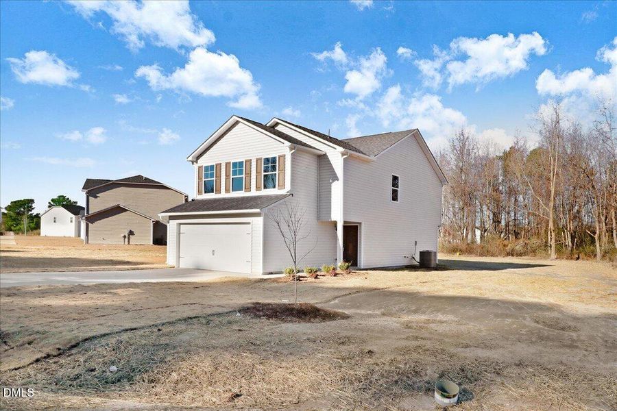 03-Driveway and side exterior of home in