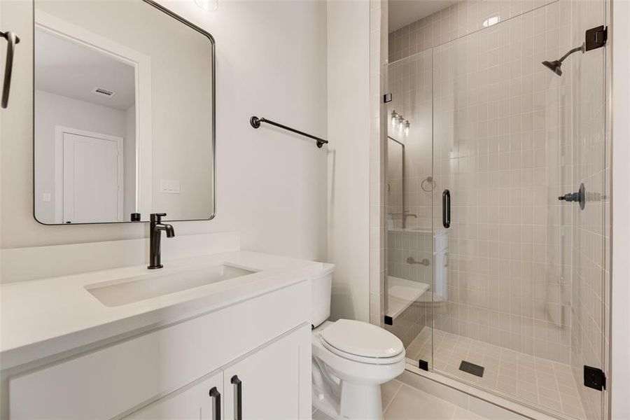 Full bathroom with vanity, a shower stall, and light tile patterned floors