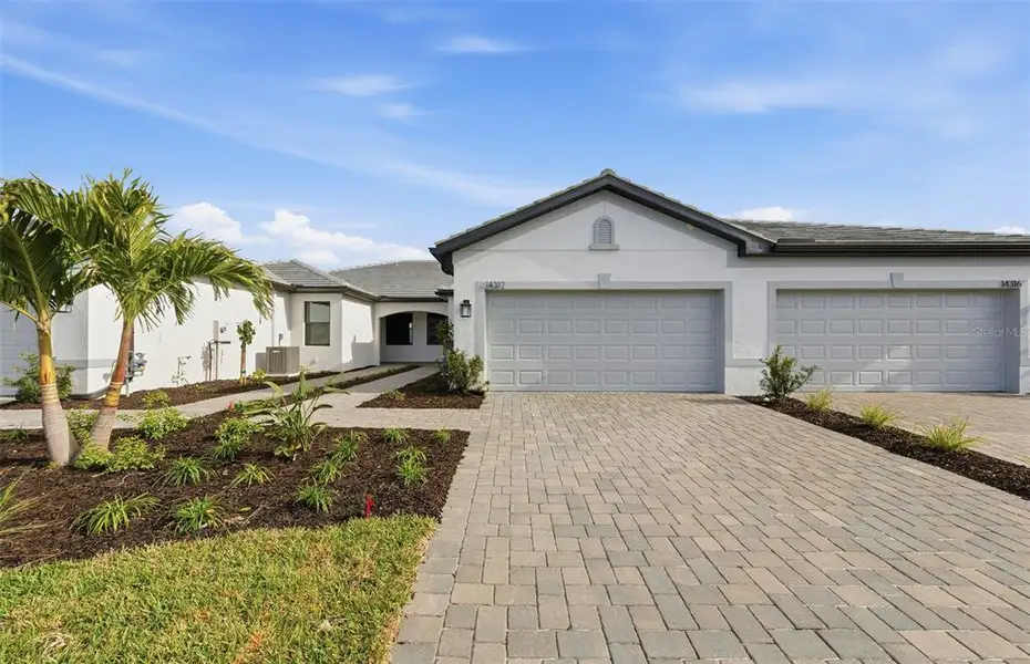 Front exterior of a new home in Talon Preserve on Palmer Ranch, Nokomis, FL, highlighting curb appeal (Image 1). Front exterior of a new home in Talon Preserve on Palmer Ranch, Nokomis, FL, highlighting curb appeal (Image 1).
