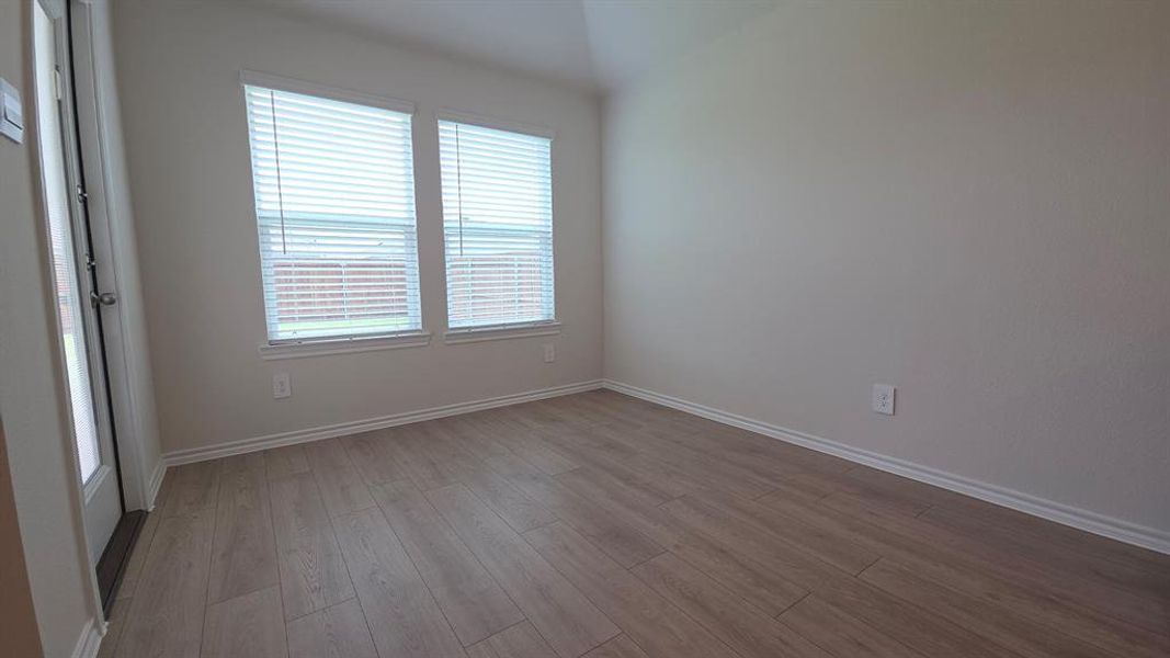 Interior space featuring wood-finish flooring and neutral wall tones Interior space featuring wood-finish flooring and neutral wall tones